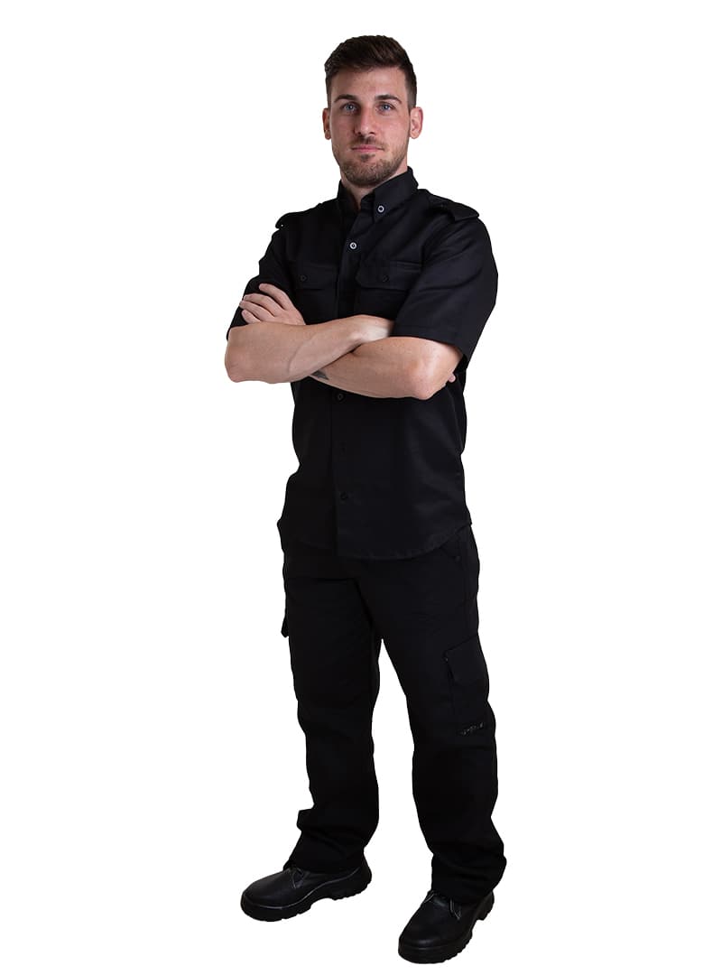 Security professional wearing a black tactical uniform with cargo trousers.