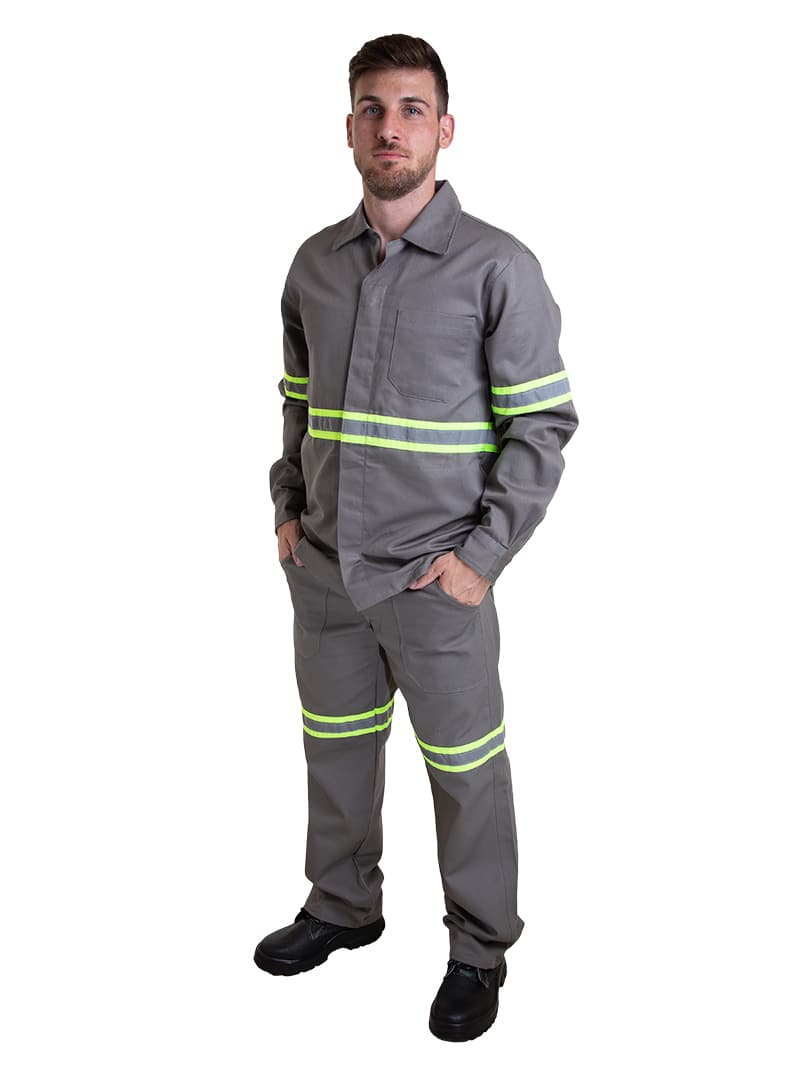 Worker wearing a grey industrial uniform set with reflective safety striping.