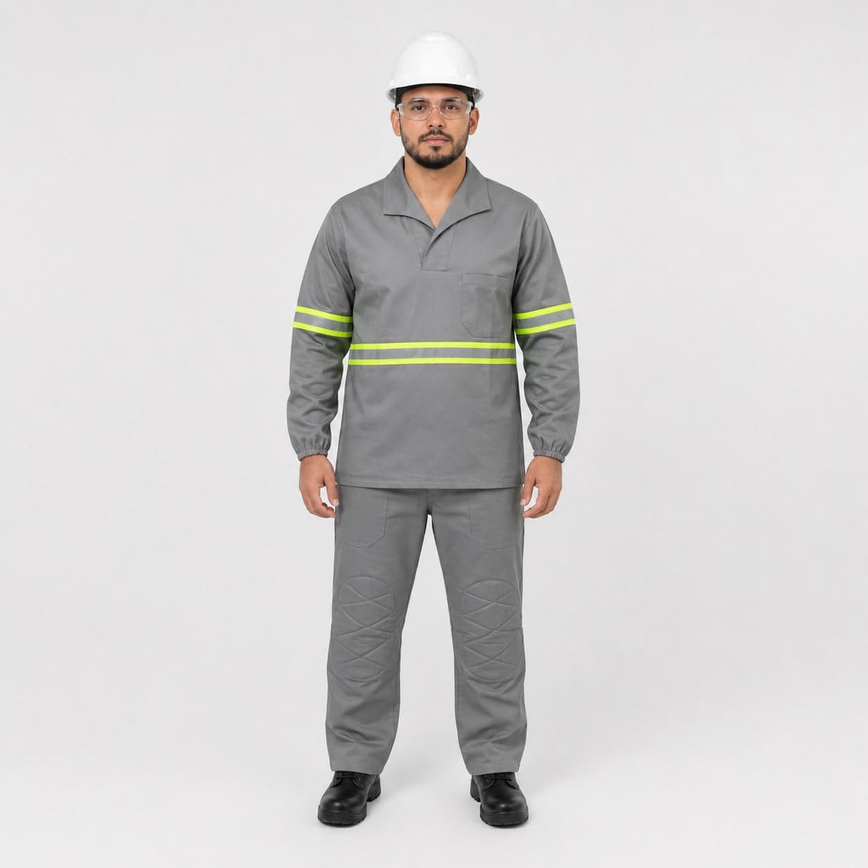 Worker in a grey industrial uniform with reflective striping, hard hat and safety glasses.